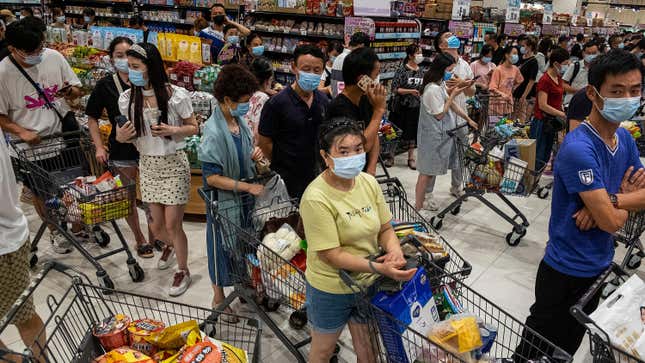 People line up to pay in a supermarket on August 2, 2021 in Wuhan, Hubei Province, China.