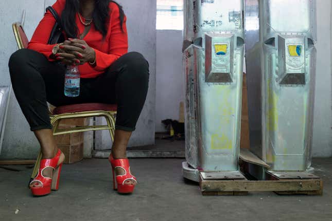 Therese Kirongozi sits in the workshop in Kinshasa.