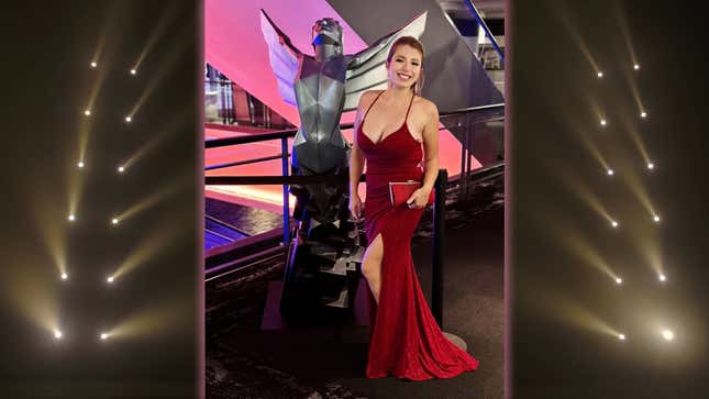 Lexie Brooks stands in a glittery red dress and matching clutch at The Game Awards 2023.