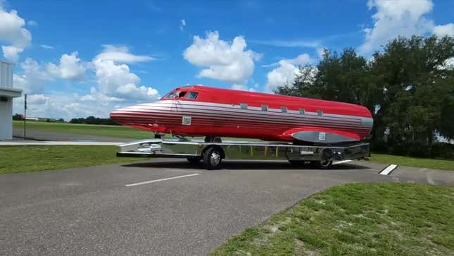 A photo showing an RV made from a plane body driving on a road. 