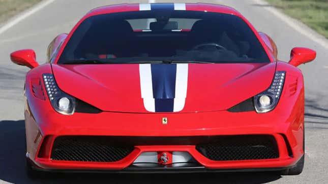 A red Ferrari 458 Speciale with white and blue stripes is parked on pavement.