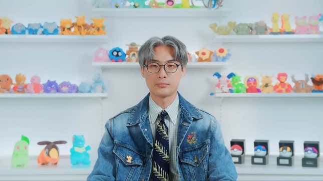 Takato Utsunomiya sits in front of his pharmacy shelves of Pokemon toys.
