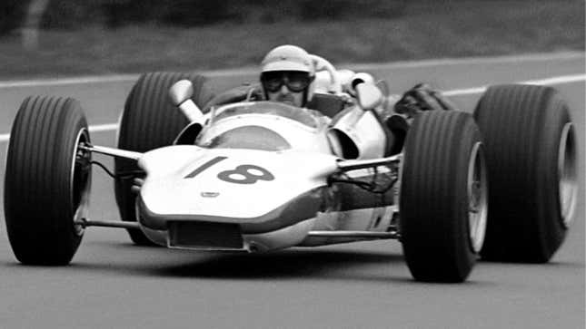 The number 18 Honda RA302 racing in Formula 1. 