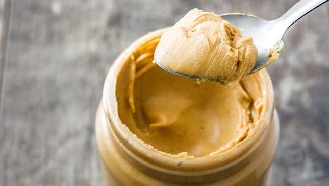 peanut butter jar with spoonful scooped out 
