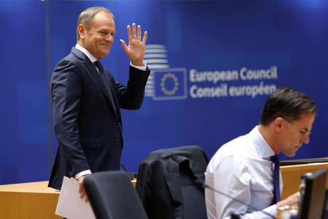 Poland&#39;s Prime Minister Donald Tusk, left, waves as he arrives for a round table meeting at an EU summit in Brussels, Friday, Dec. 15, 2023. European Union leaders conclude a second day of meetings in which they will discuss the situation in Gaza. (AP Photo/Omar Havana)