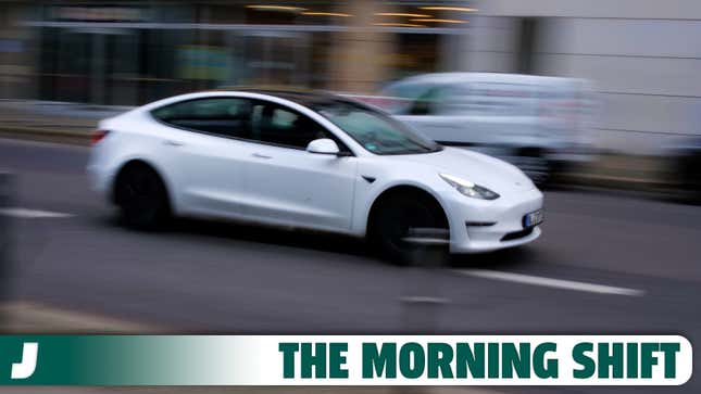 A photo of a Tesla Model 3 EV driving on the street. 