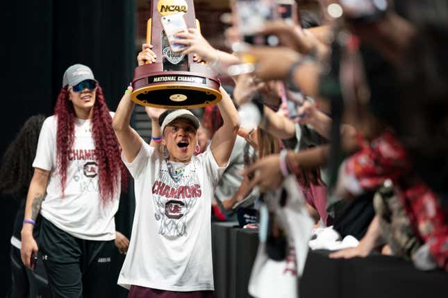 COLUMBIA, SOUTH CAROLINA - APRIL 8: South Carolina coach Dawn Staley raises the NCAA Women’s Basketball Championship trophy during a celebration at Colonial Life Arena on April 8, 2024 in Columbia, South Carolina. University classes that were scheduled during the event were canceled. The South Carolina Gamecocks defeated the Iowa Hawkeyes 87-75 to cap a perfect season. 