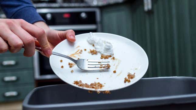 Scraping food into trash can