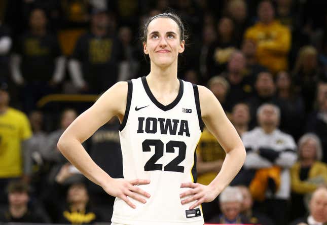 Guard Caitlin Clark of the Iowa Hawkeyes listens as the crowd cheers after breaking the NCAA women’s all-time scoring record during the game against the Michigan Wolverines at Carver-Hawkeye Arena on February 15, 2024.
