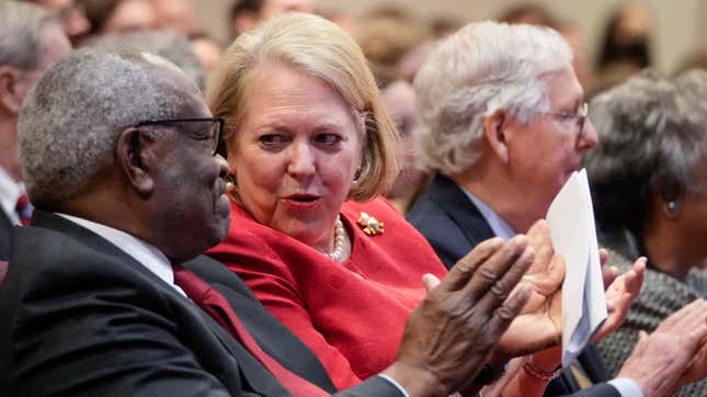 Associate Supreme Court Justice Clarence Thomas sits with his wife and conservative activist Virginia Thomas while he waits to speak at the Heritage Foundation on October 21, 2021 in Washington, DC.