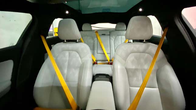 A photo of the interior, showing all the seats and their bright gold seatbelts. 