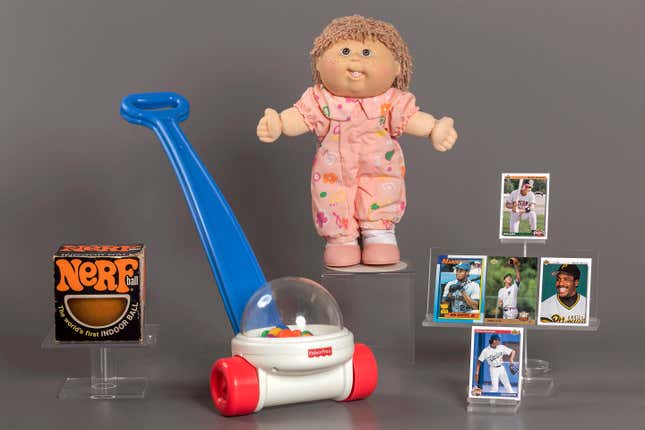 This photo provided by the National Toy Hall of Fame shows their 2023 inductees. From left, NERF, Fisher-Price Corn Popper, Cabbage Patch Kids, and baseball cards. They will be permanently installed at the Toy Hall of Fame in Rochester, NY. (National Toy Hall of Fame via AP)