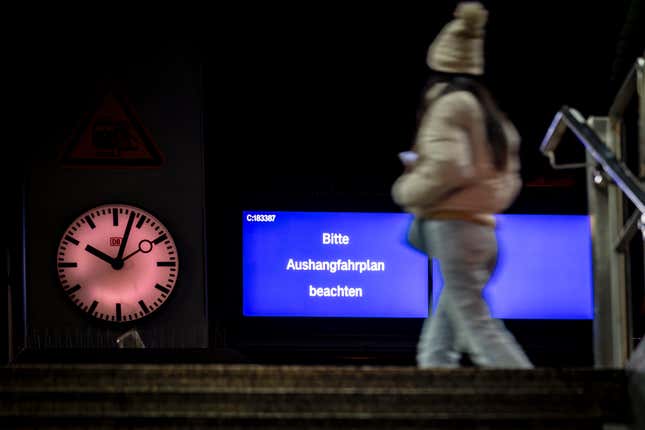 A woman walks across a platform, a notice on the display board reads &quot;Please note the posted timetable&quot; in Duesseldorf, Germany, Thursday, Dec. 7, 2023. The German Train Drivers&#39; Union (GDL) began a 24-hour warning strike in the evening. (Christoph Reichwein/dpa via AP)