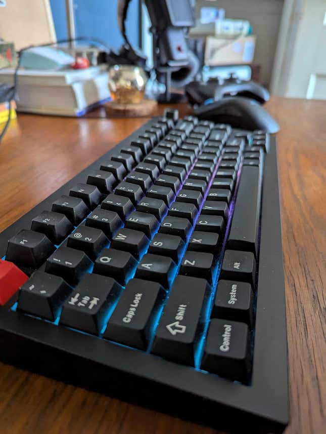 A keyboard sits on a desk. 