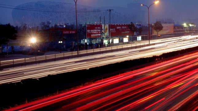 A long exposure photo of blurry car lights on a highway 