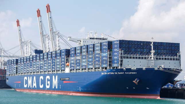 A photo of a large blue ship filled with containers. 