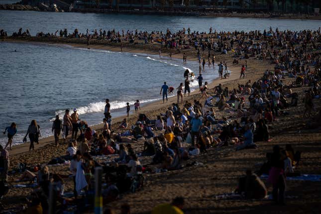 FILE - People sunbathe on a beach in Barcelona, ​​Spain, Sunday, March 12, 2023. According to Spain's national statistics, in 2023 Spain recorded 85.1 million international tourists, an increase of 19% compared to the same period last year. The institute reported. This number is up from 83.5 million people in 2019, the year before the coronavirus disease (COVID-19) pandemic hit the global travel industry.  (AP Photo/Emilio Morenatti, File)