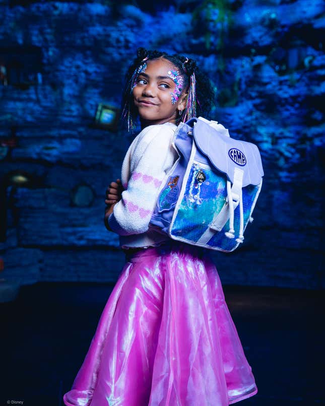 Little girl with The little mermaid camp backpack and little mermaid skirt