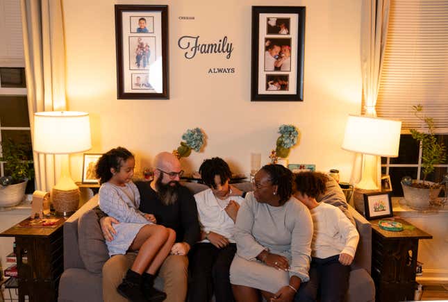 WASHINGTON, DC - November 20: Michelle Farris and her husband Tim Farris pose for photos with their children Abigail, 9, Seth, 13, and Owen, 9, at home in Glen Burnie, MD on November 20, 2023. Michelle Farris’ great great grandmother’s brother Moses Boone, then a two-year-old, died of tuberculosis. When he died, his brain was taken for the “racial brain collection” at the Smithsonian Institution. 