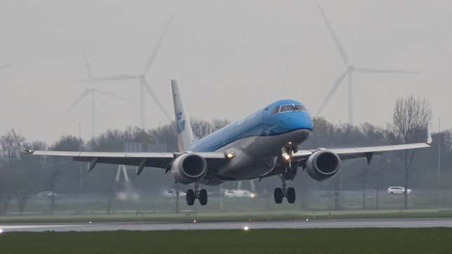 A photo of a KLM plane landing at Amsterdam airport. 