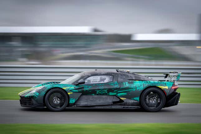Side view of a camouflaged Aston Martin Valhalla driving on track