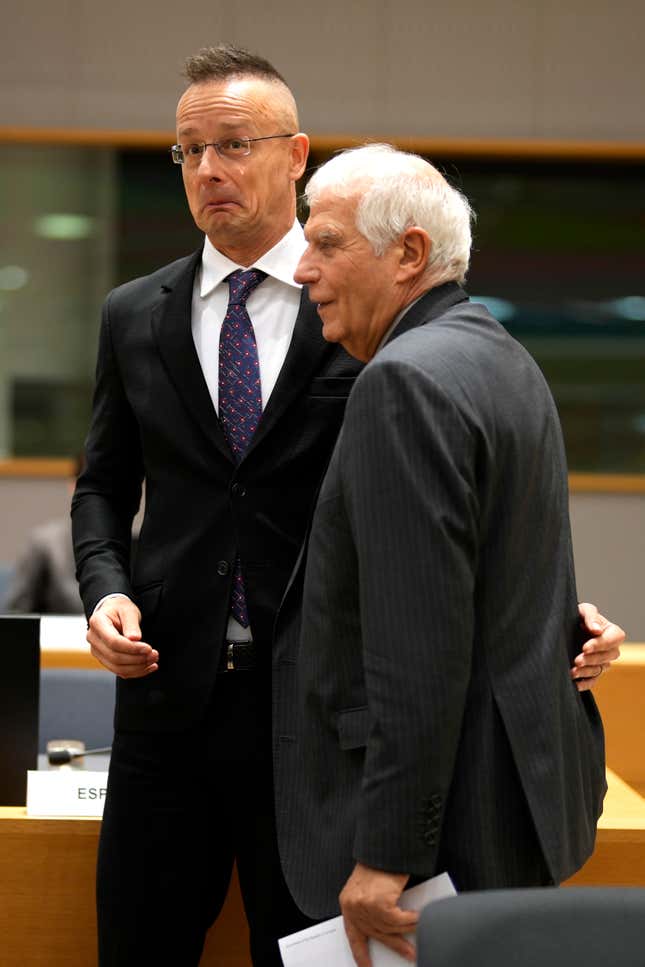 Hungary&#39;s Foreign Minister Peter Szijjarto, left, speaks with European Union foreign policy chief Josep Borrell during a meeting of EU foreign ministers at the European Council building in Brussels, Monday, Dec. 11, 2023. Pressure mounted on Hungary on Monday not to veto the opening of European Union membership talks and the supply of economic aid to war-torn Ukraine at a pivotal EU summit this week, after Prime Minister Viktor Orban demanded that the issue be struck from the agenda. (AP Photo/Virginia Mayo)