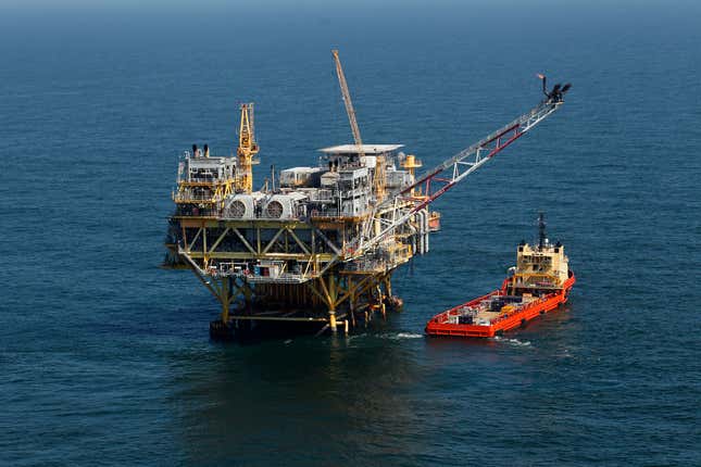 FILE - A rig and supply vessel are viewed in the Gulf of Mexico off the cost of Louisiana, April 10, 2011. A sale of federal Gulf of Mexico oil and gas leases that had been scheduled for Wednesday, Nov. 8, 2023, was delayed Thursday, Oct. 26, 2023, by a federal appeals court, pending court arguments that focus on protections for an endangered whale species. (AP Photo/Gerald Herbert, File)