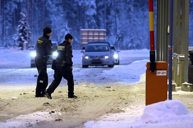 FILE - Finnish border guards walk at Vaalimaa border check point between Finland and Russia in Virolahti, Finland, on Dec. 15, 2023. Finland will extend the closure of its border crossing points with Russia beyond the current April 14 deadline “until further notice” due to a high risk of organized migration orchestrated by Moscow, the Finnish government said on Thursday, April 4, 2024. (Heikki Saukkomaa/Lehtikuva via AP)