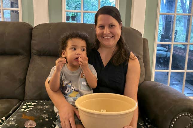 Megan Cherry sits for a portrait with her two-year-old son in their home in Temple Terrace, Fla., on Tuesday, Jan. 9, 2024. Cherry is among millions of Americans who are feeling the ongoing impacts of inflation, which hit four-decade highs in 2022. (AP Photo/Laura Bargfeld)