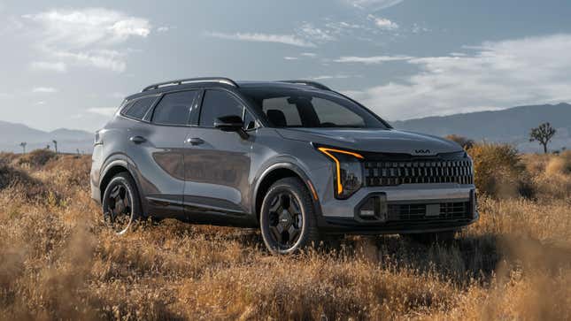 A 2026 Kia Sportage parked off-road in a grassy area