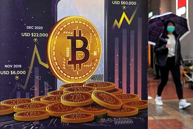 FILE - An advertisement for Bitcoin cryptocurrency is displayed on a street in Hong Kong, on Feb. 17, 2022. Bitcoin briefly hit an all-time high Tuesday, March 5, 2024, with the world&#39;s largest cryptocurrency surpassing $68,800, according to CoinMarketCap. (AP Photo/Kin Cheung, File)