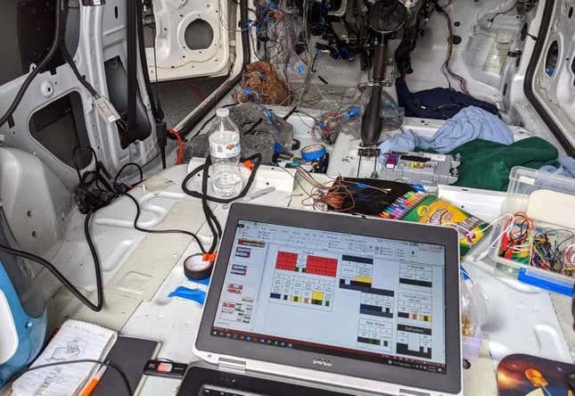 A stripped car interior with many loose wires.