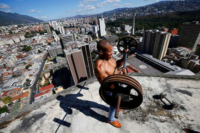 A resident lifts weights on the 28th floor of Torre Silva