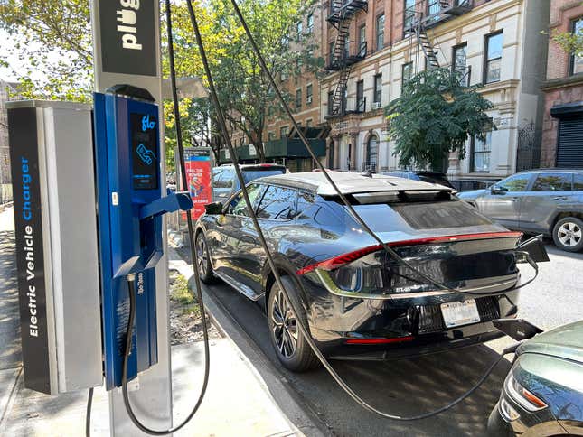 A Kia EV6 charging on the street in New York City.