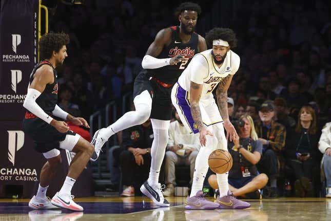 Nov 12, 2023; Los Angeles, California, USA; Los Angeles Lakers forward Anthony Davis (3) dribbles against Portland Trail Blazers center Deandre Ayton (2) during the first half of a game at Crypto.com Arena.