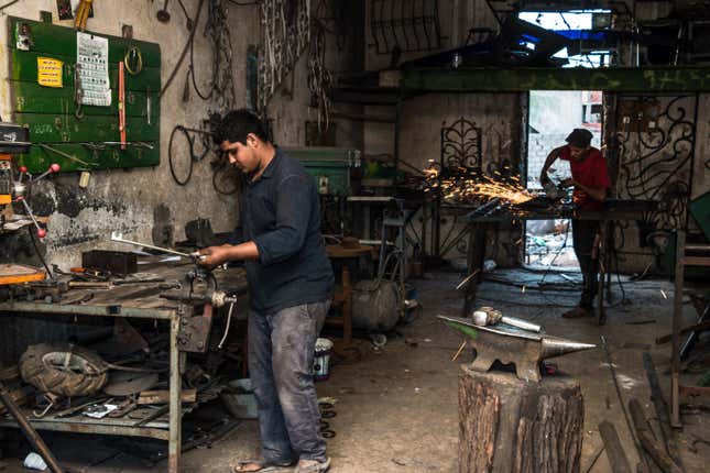 Two young men work in a metal-crafting shop in Sidi Bouzid. Unemployment in interior cities like this is around 30%.