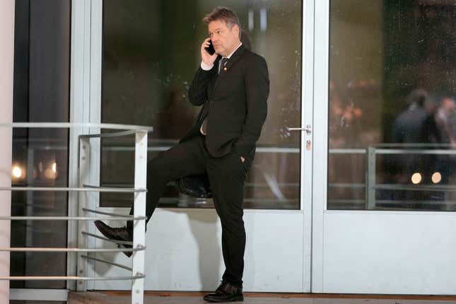 FILE - Robert Habeck, German Vice Chancellor and Federal Minister for Economic Affairs and Climate Action makes a phone call at the chancellery in Berlin, Germany, on Nov. 22, 2023. A group of farmers prevented Germany&#39;s vice chancellor disembarking from a ferry hours after the government partially climbed down on cost-saving plans that infuriated the agricultural sector, a protest that drew condemnation from government and opposition figures. (AP Photo/Markus Schreiber)