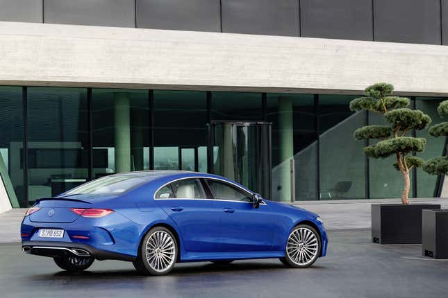 A bright blue CLS class parked in front of an office building