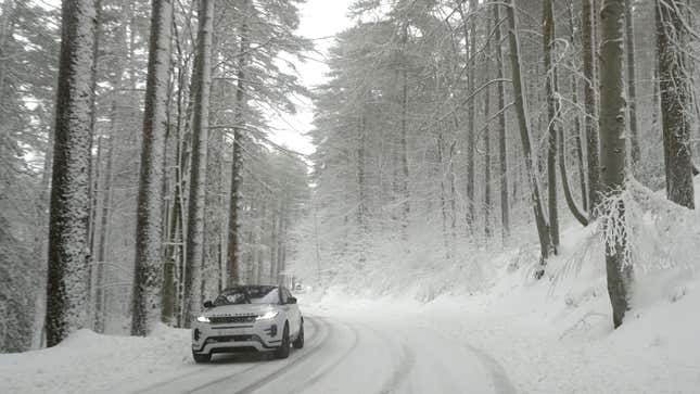 A photo of a Range Rover Evoque driving on a snowy road. 