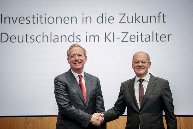 Federal Chancellor Olaf Scholz, right, and Vice Chair and President of Microsoft Corporation Brad Smith shake hands in Berlin, `Thursday, Feb. 15, 2024, after a press conference held by Microsoft Deutschland GmbH on the company&#39;s investments in the AI sector in Germany. Chancellor Olaf Scholz welcomed an announcement by Microsoft on Thursday that it would invest more than 3.2 billion euros ($3.4 billion) in Germany over the next two years to massively expand its data center capacities for applications in the field of artificial intelligence and cloud computing. (Kay Nietfeld/dpa via AP)