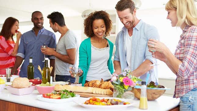 Party guests serving food from buffet