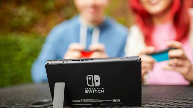 Two people are shown playing a Switch.
