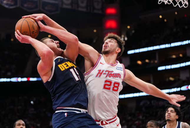 HOUSTON, TEXAS - NOVEMBER 24: Alperen Sengun #28 of the Houston Rockets attempts to block the shot of Nikola Jokic #15 of the Denver Nuggets in the first quarter of an NBA In-Season Tournament game at Toyota Center on November 24, 2023 in Houston, Texas. NOTE TO USER: User expressly acknowledges and agrees that, by downloading and or using this photograph, User is consenting to the terms and conditions of the Getty Images License Agreement. (Photo by Alex Bierens de Haan/Getty Images)