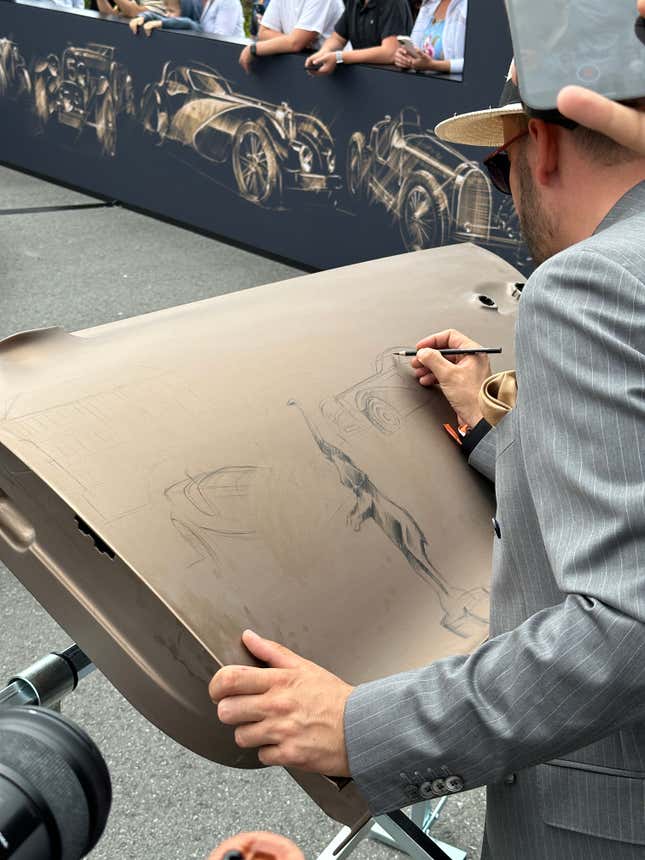 Bugatti designer Jascha Straub drawing on a Chiron door