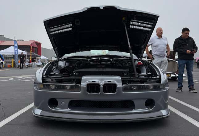 Front view of the silver BMW 858 CSL with the hood open