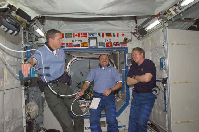 Two astronauts and a cosmonaut onboard the International Space Station in 2001.