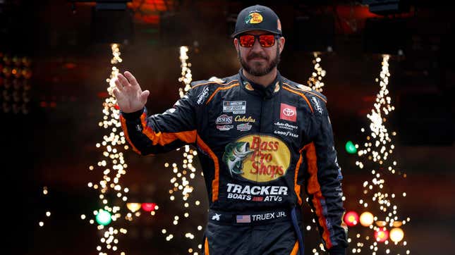 Martin Truex Jr., driver of the #19 Bass Pro Shops Toyota, waves to fans as he walks onstage during driver intros prior to the NASCAR Cup Series Cook Out 400 at Richmond Raceway on July 30, 2023 in Richmond, Virginia.