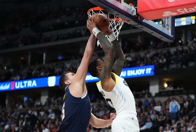 Oct 30, 2023; Denver, Colorado, USA; Denver Nuggets center Nikola Jokic (15) blocks the shot of Utah Jazz forward John Collins (20) in the second quarter at Ball Arena.