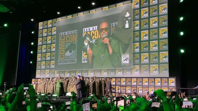 A screenshot of footage showing Robert Downey Jr. announcing his return as Doctor Doom onstage at San Diego Comic Con.