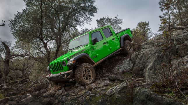 A photo of a green Jeep Gladiator driving down a slope. 